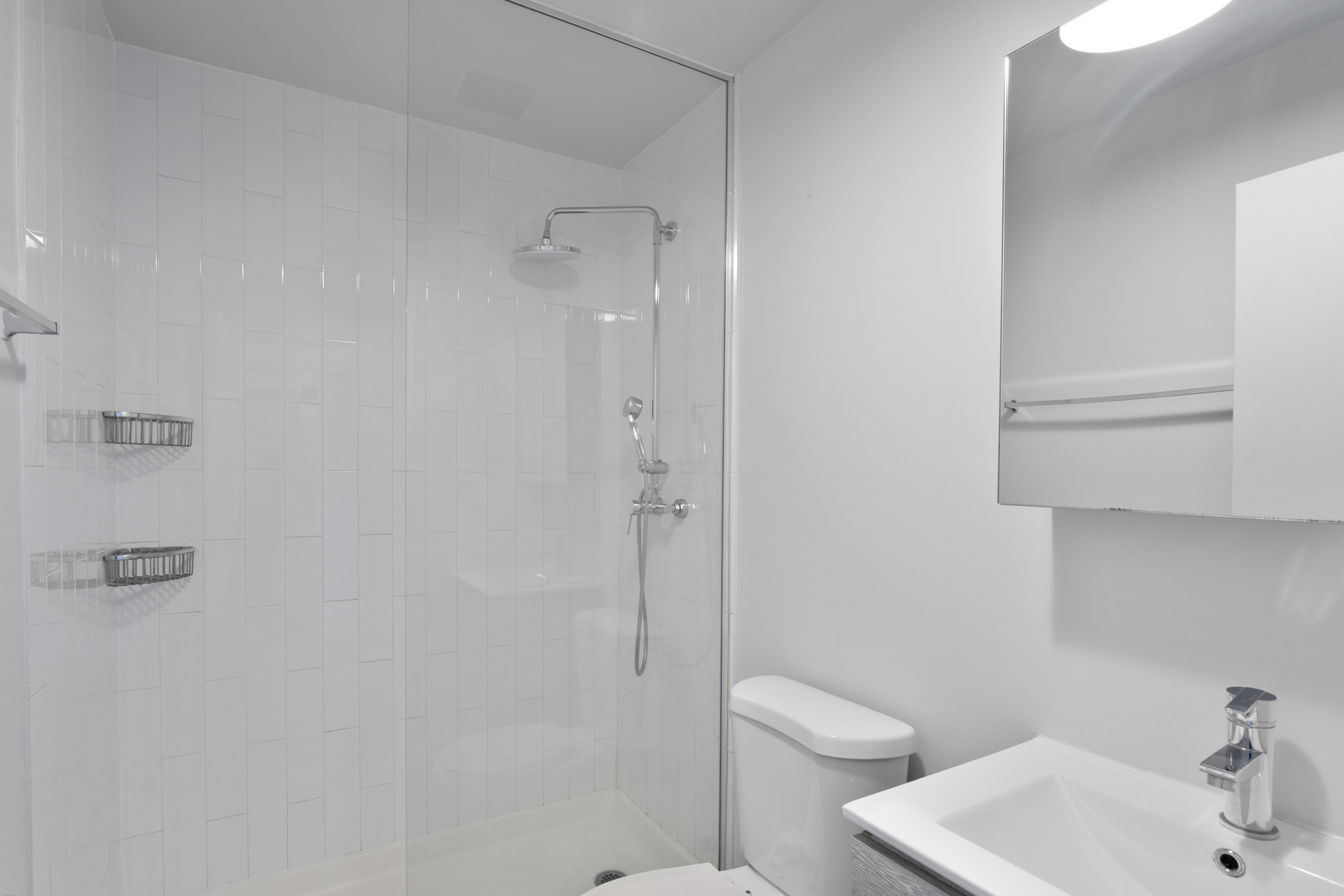 1325 West Wilson Avenue, Unit 1006 Chicago, IL 60640 - Photo 9 of 21 a bathroom with a toilet sink and shower