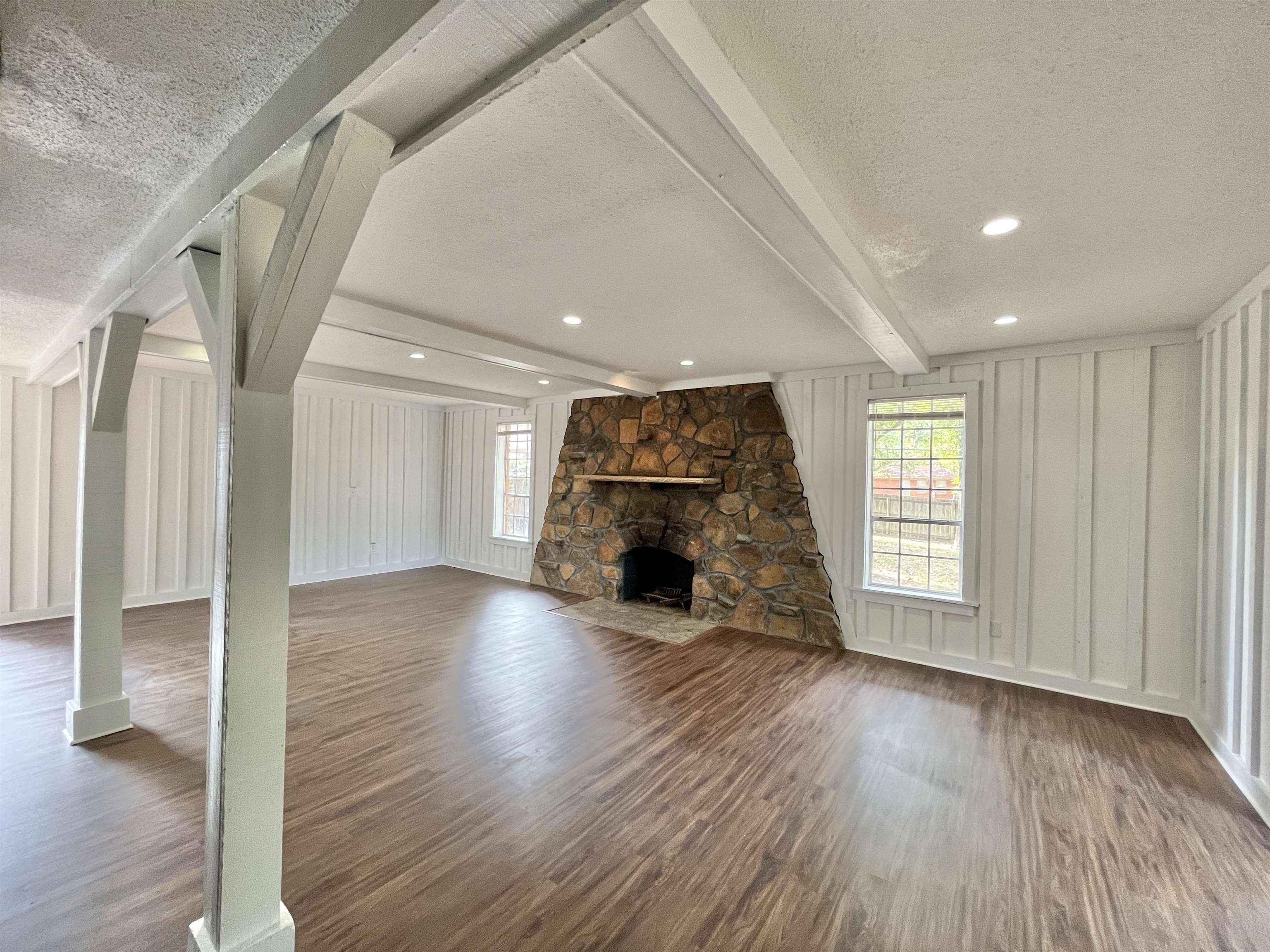 2973 Bannockburn Road Memphis, TN 38128 - Photo 15 of 26 a view of empty room with wooden floor and fireplace