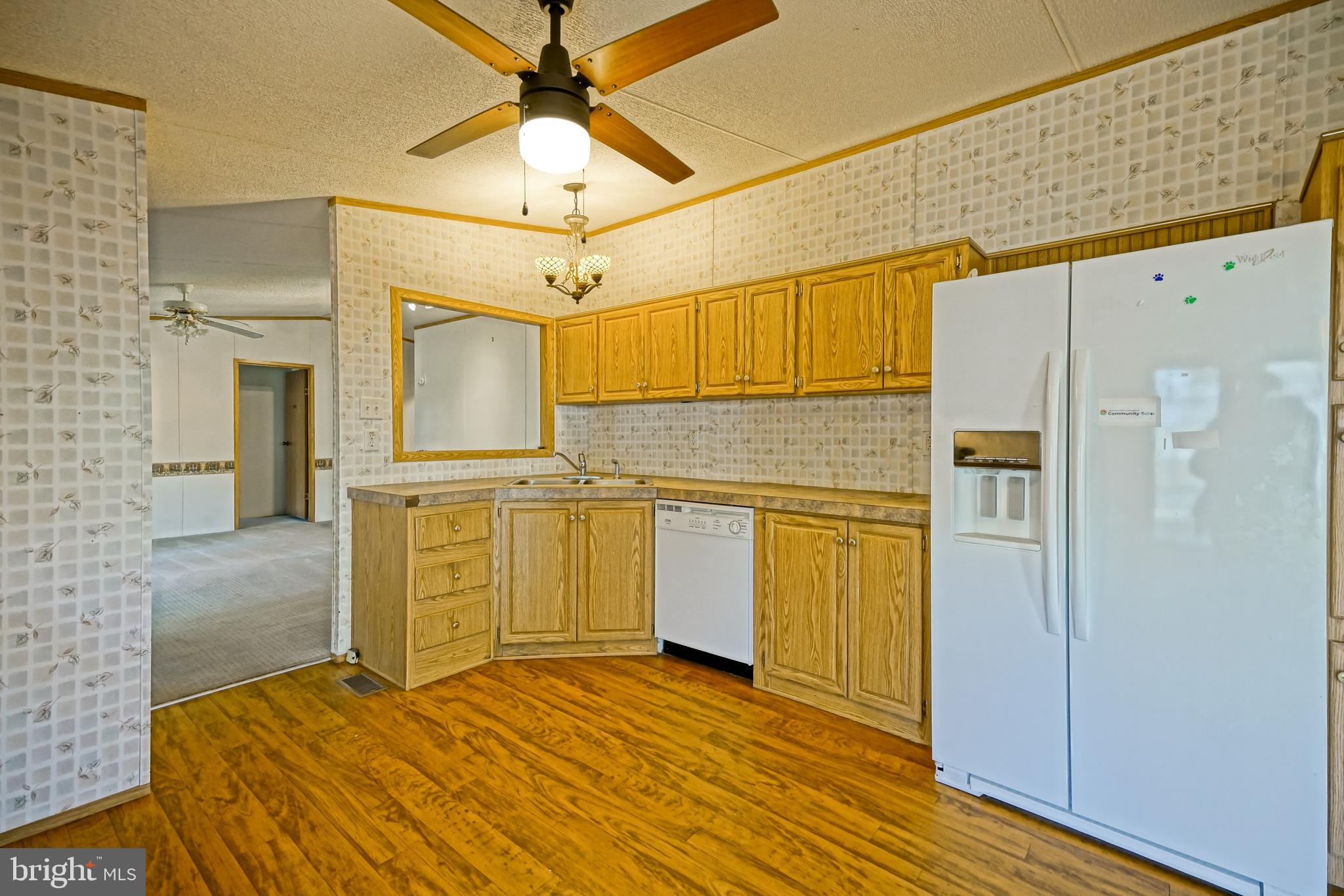 22916 Pine Road Lewes, DE 19958 - Photo 12 of 35 a view of a kitchen with a refrigerator and a stove