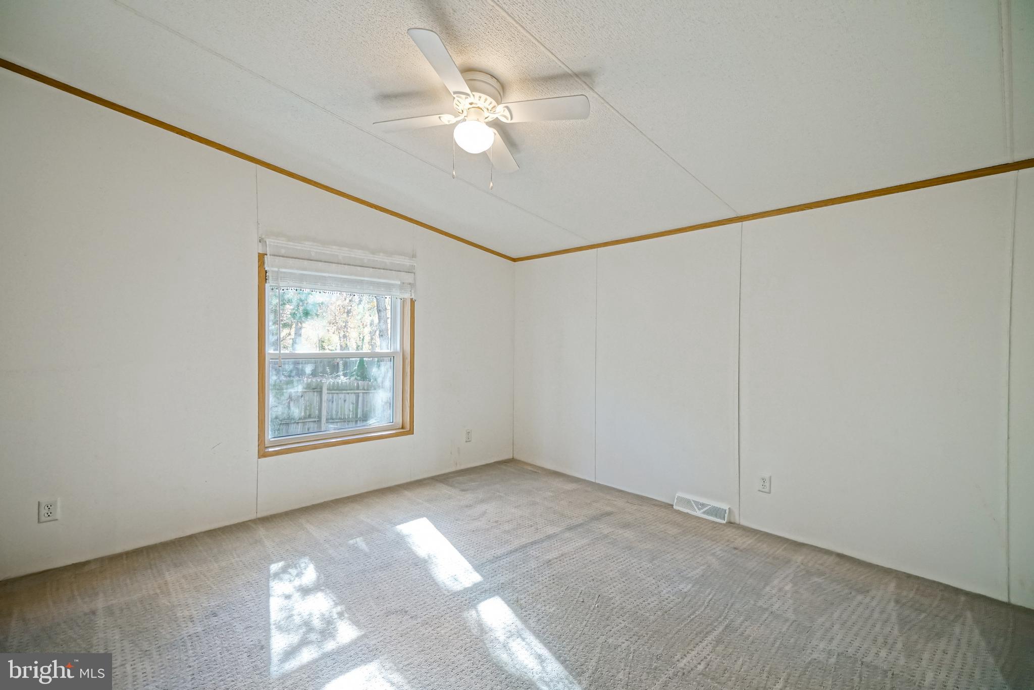22916 Pine Road Lewes, DE 19958 - Photo 21 of 35 an empty room with windows and fan