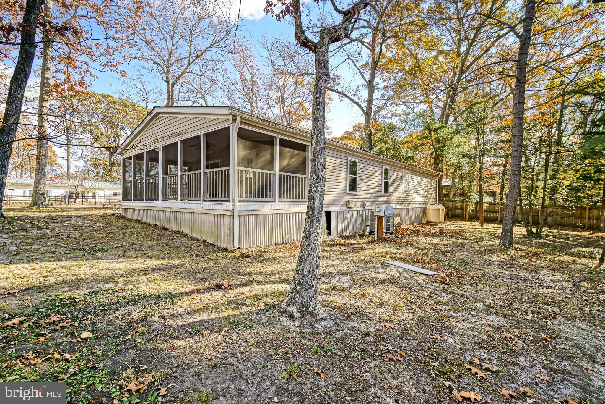 22916 Pine Road Lewes, DE 19958 - Photo 28 of 35 a house with trees in front of it