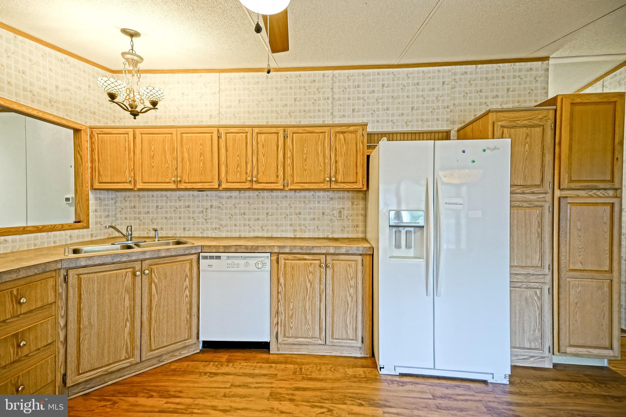 22916 Pine Road Lewes, DE 19958 - Photo 7 of 35 a kitchen with stainless steel appliances granite countertop a refrigerator and a sink