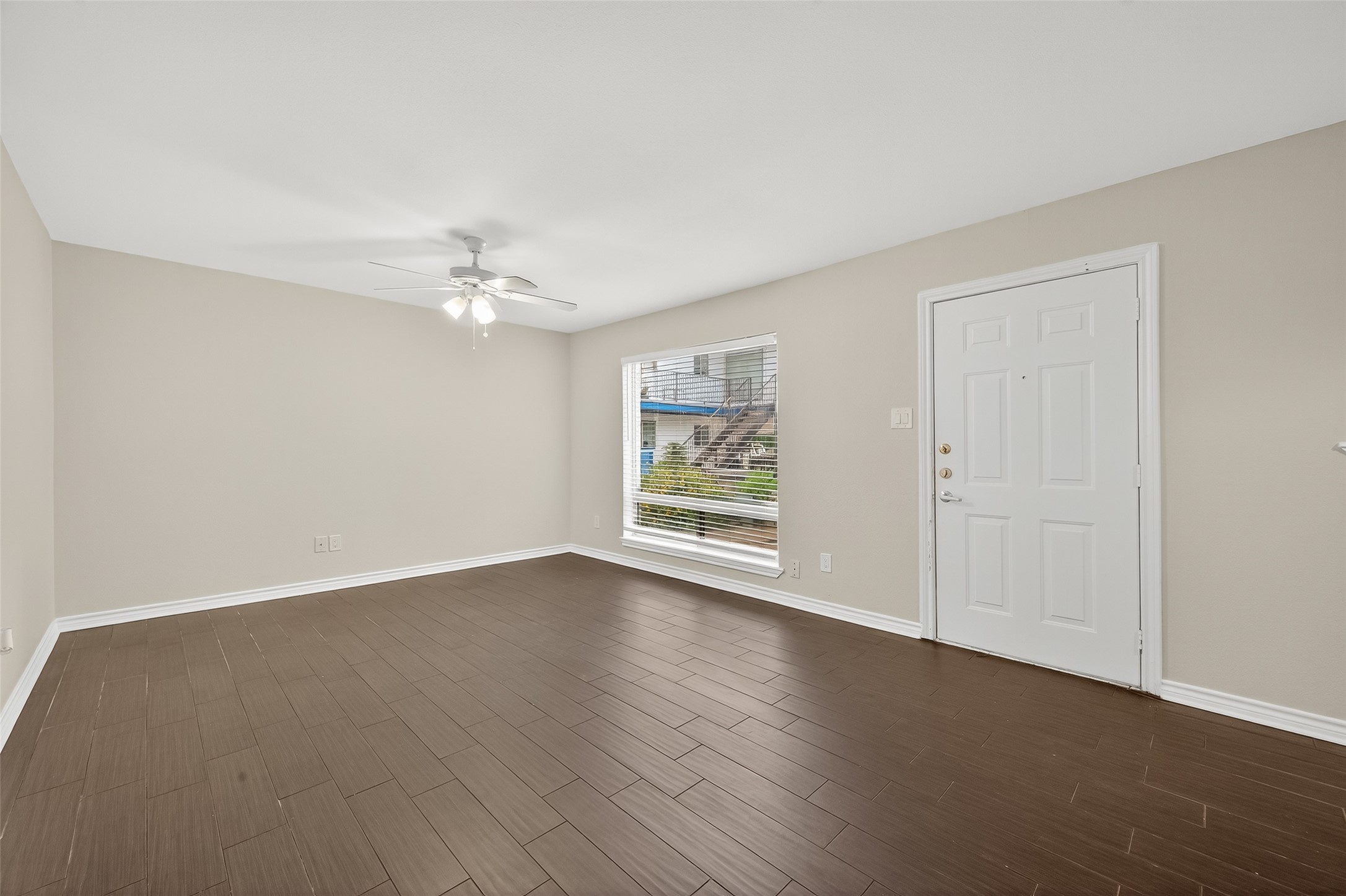 2020 Huldy Street, Unit 2 Houston, TX 77019 - Photo 11 of 34 a view of an empty room with wooden floor and a window