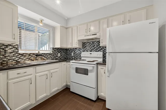 a white refrigerator freezer sitting inside of a kitchen