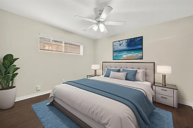 a bedroom with bed and a potted plant