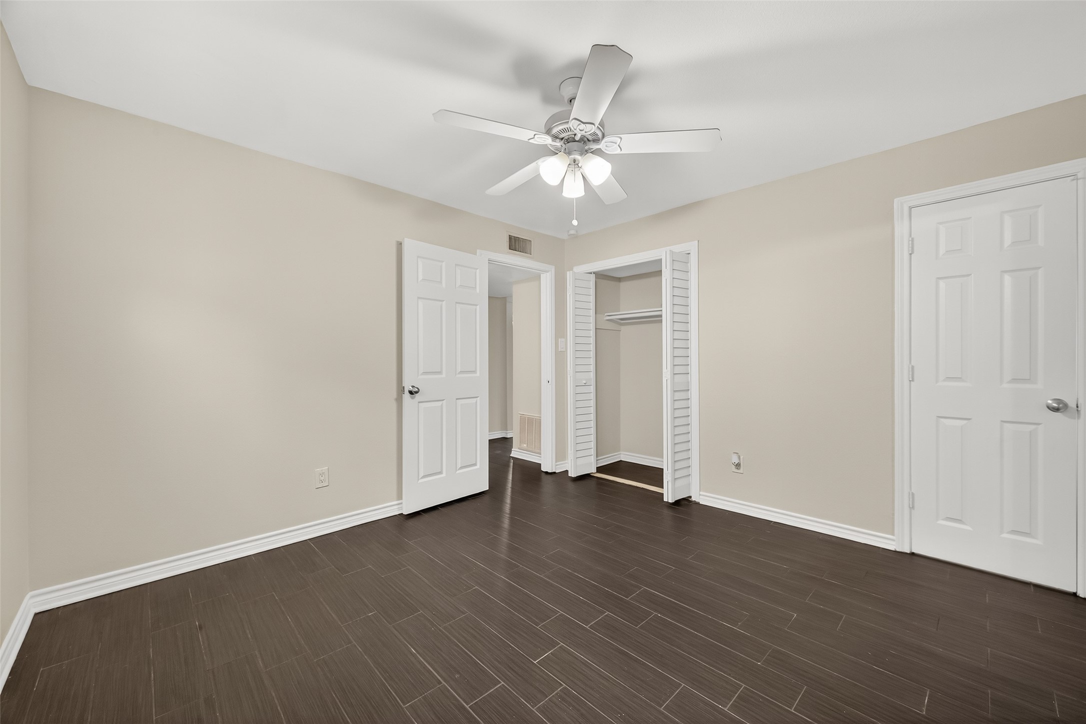 2020 Huldy Street, Unit 2 Houston, TX 77019 - Photo 30 of 34 an empty room with wooden floor fan and windows