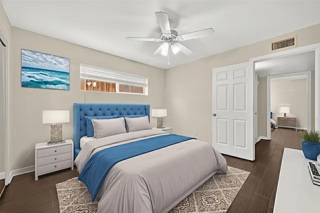 a bedroom with a bed and a chandelier