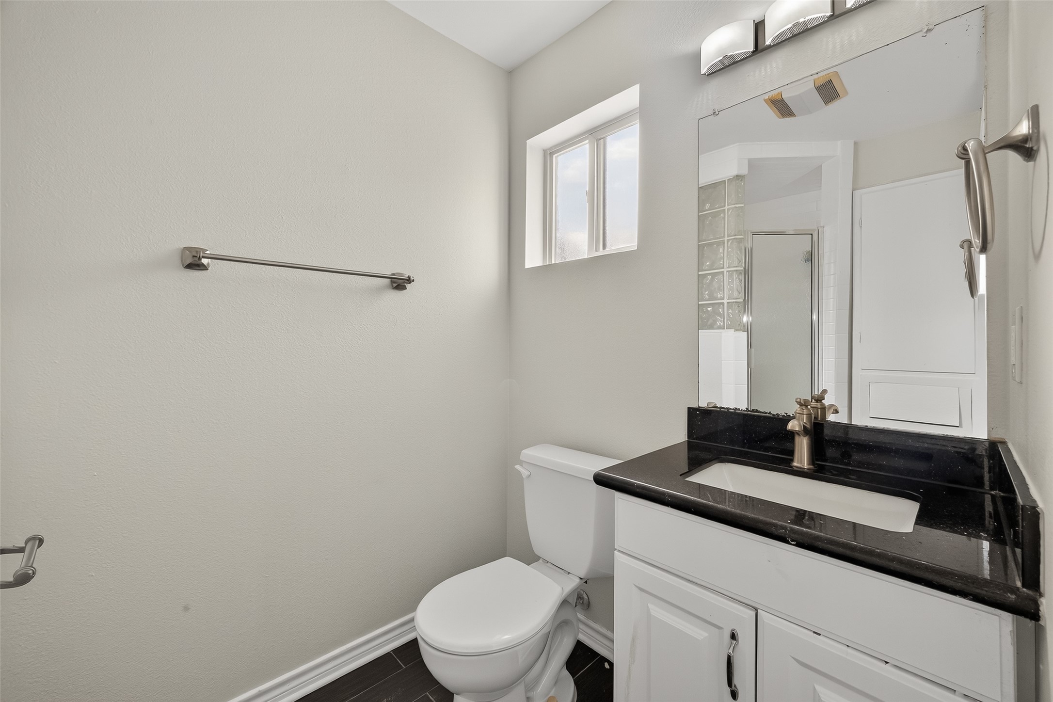 2020 Huldy Street, Unit 2 Houston, TX 77019 - Photo 33 of 34 a bathroom with a granite countertop sink a toilet and a mirror