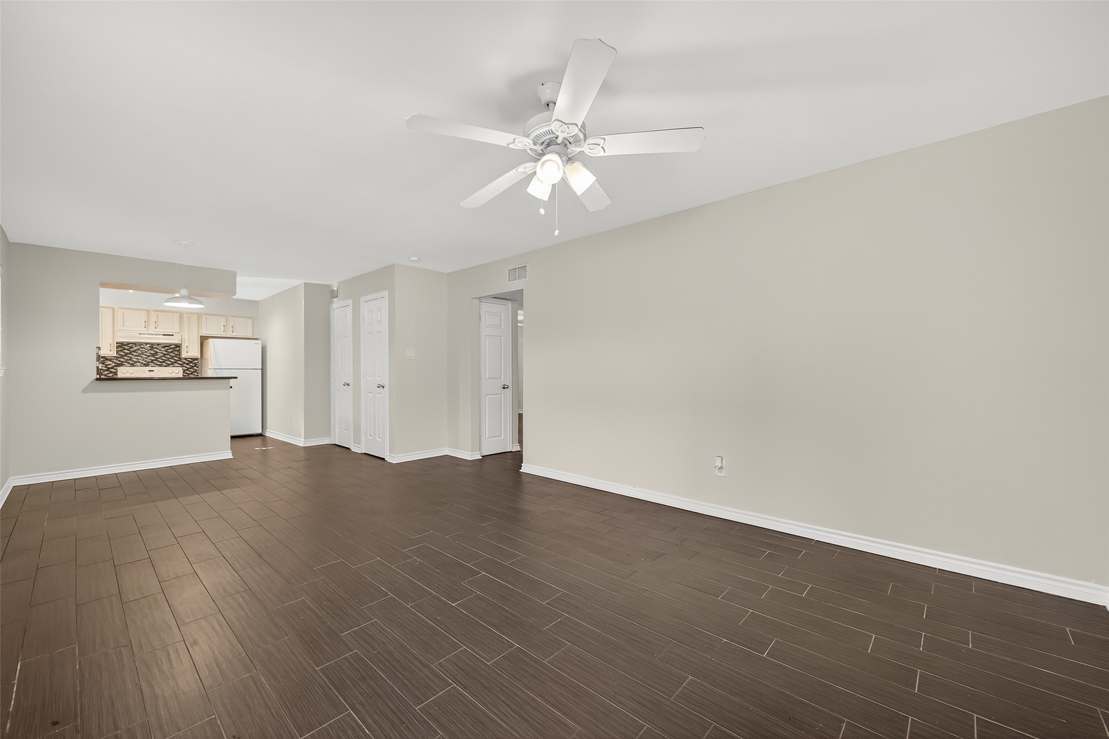 2020 Huldy Street, Unit 2 Houston, TX 77019 - Photo 8 of 34 an empty room with wooden floor fan and windows