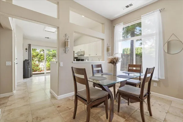 a dining room with furniture and window