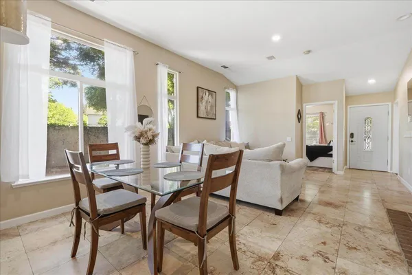 a view of a dining room with furniture and a large window