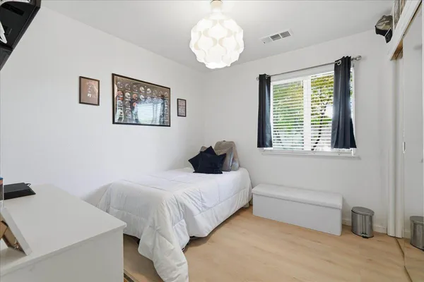a bedroom with a bed and a table