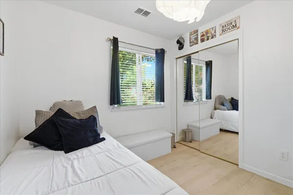 a bedroom with a bed and a large window