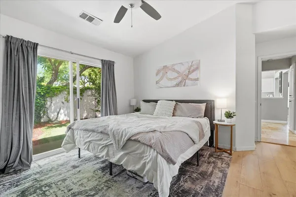 a bedroom with a bed and a large window