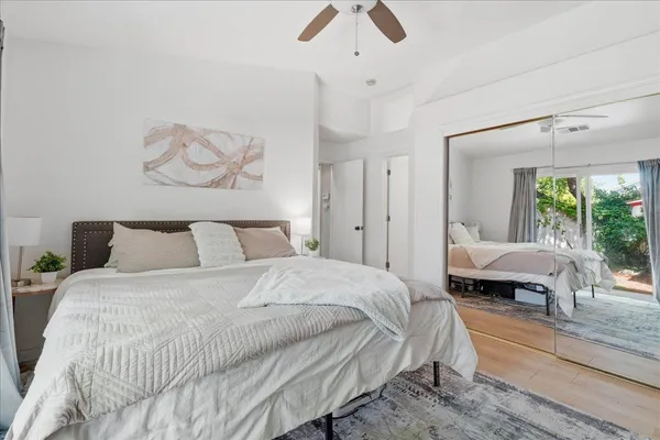 a bedroom with a large bed and a window