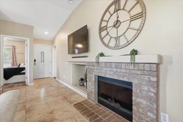 a living room with furniture a mirror and a fireplace