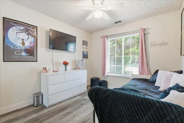 a bedroom with furniture and a window