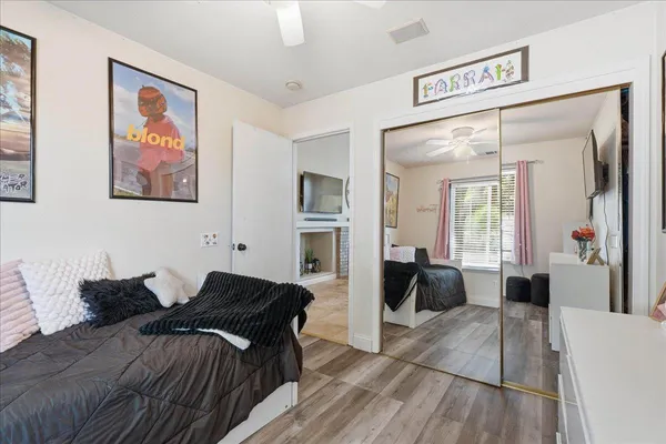 a bedroom with a bed and glass windows