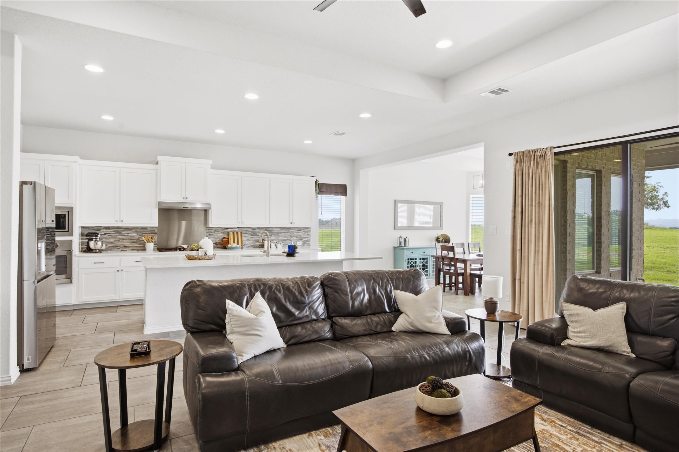 192 Raptor Beak Way Cedar Creek, TX 78612 - Photo 10 of 38 Open-concept living space featuring a tray ceiling, recessed lighting, and a ceiling fan