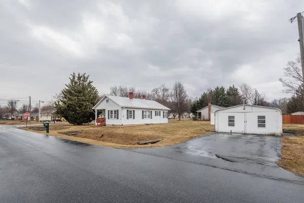 a view of a white house with a yard
