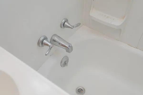 a bathroom with a bathtub a shower a sink and a window