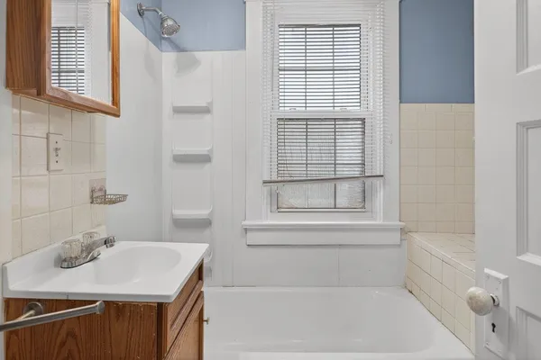 a bathroom with a sink a toilet and tub