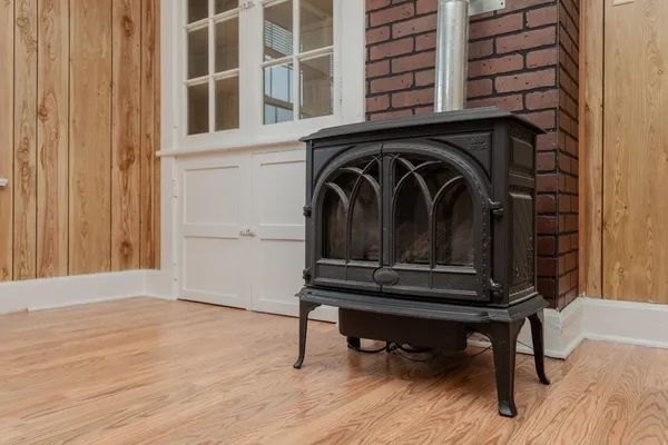 a view of a livingroom with wooden floor and a large window