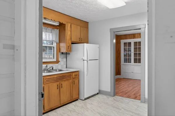 a kitchen with stainless steel appliances a stove a refrigerator and cabinets