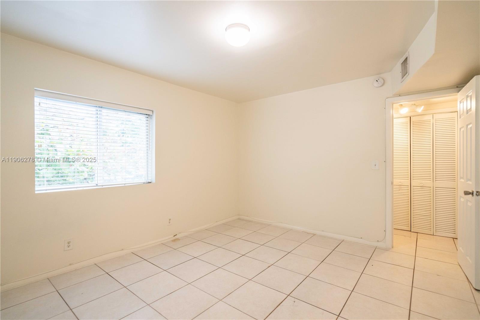 666 Northeast 80th Street, Unit 9 Miami, FL 33138 - Photo 12 of 16 a view of an empty room and window