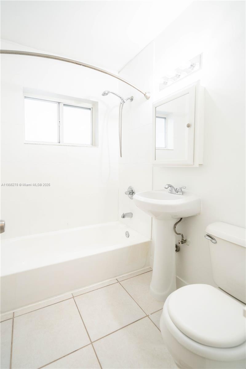 666 Northeast 80th Street, Unit 9 Miami, FL 33138 - Photo 14 of 16 a bathroom with a sink a toilet and shower