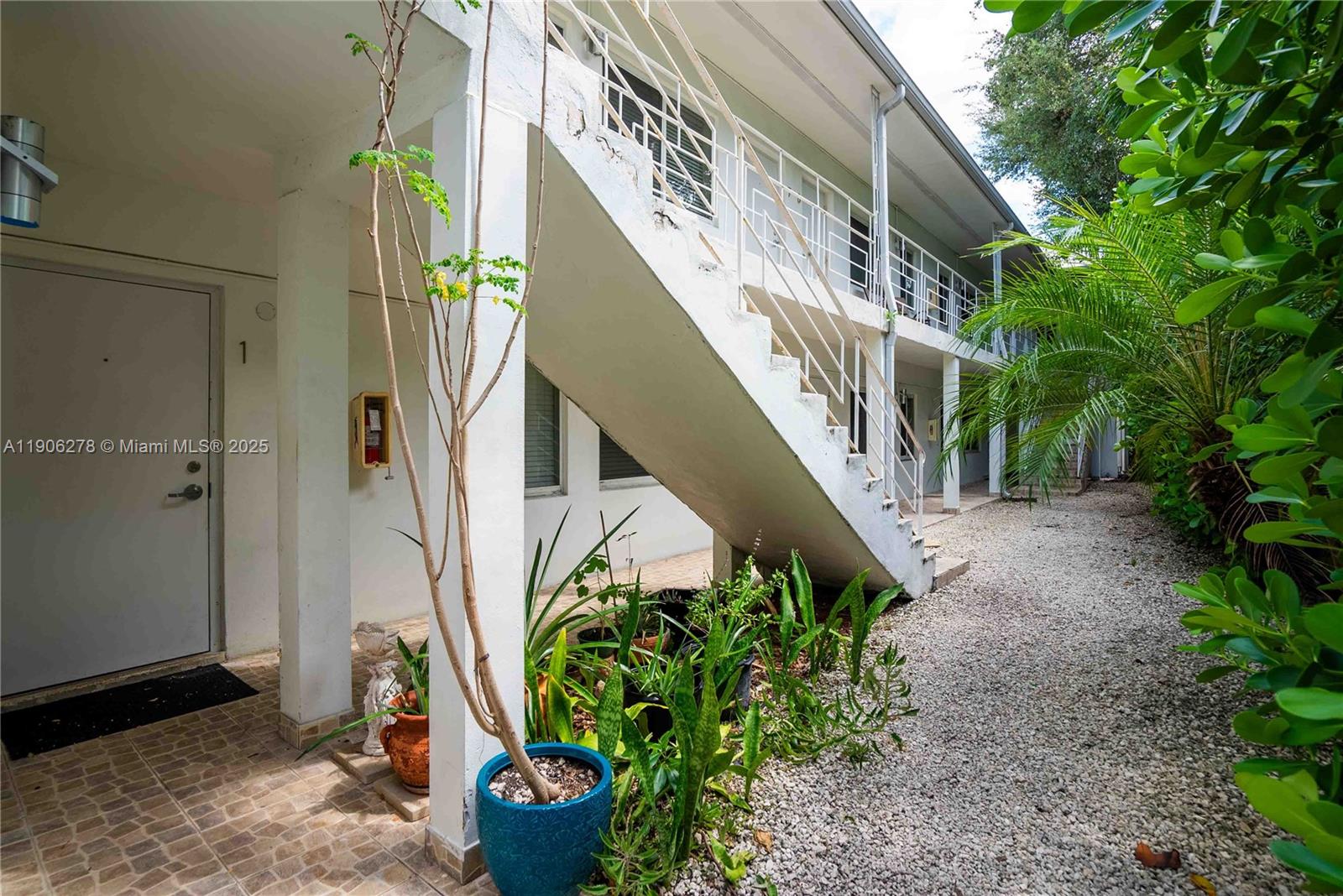 666 Northeast 80th Street, Unit 9 Miami, FL 33138 - Photo 15 of 16 a view of a potted plants with large trees