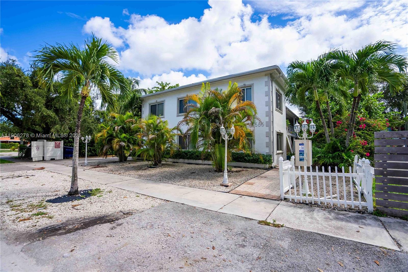 666 Northeast 80th Street, Unit 9 Miami, FL 33138 - Photo 2 of 16 a front view of a house with a yard and tree