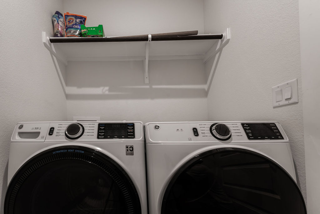 6414 Cowman Way Austin, TX 78747 - Photo 33 of 35 A dedicated laundry nook provides convenient overhead shelving above the appliances.