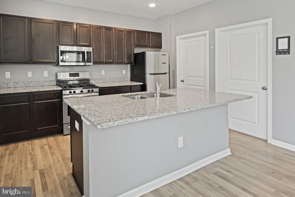705 Beechwood Drive Deptford, NJ 08096 - Photo 13 of 39 a kitchen with granite countertop wooden cabinets and a stainless steel appliances