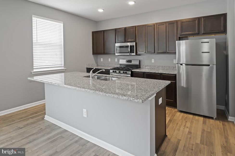 705 Beechwood Drive Deptford, NJ 08096 - Photo 15 of 39 a kitchen with kitchen island granite countertop stainless steel appliances a refrigerator microwave and sink