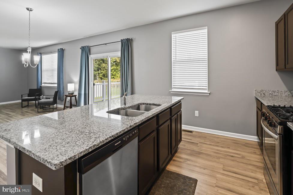 705 Beechwood Drive Deptford, NJ 08096 - Photo 16 of 39 a kitchen with granite countertop kitchen island a sink table and chairs