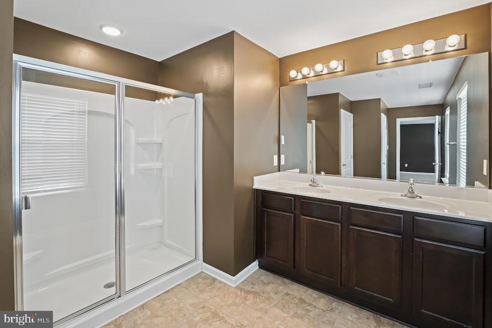 705 Beechwood Drive Deptford, NJ 08096 - Photo 24 of 39 a bathroom with a double vanity sink and a mirror