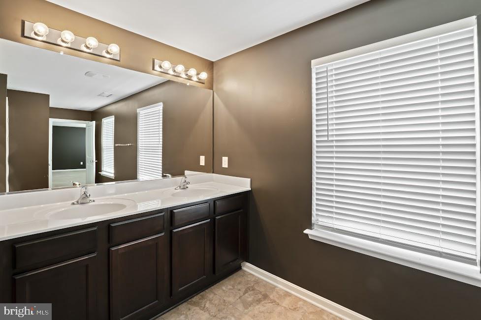 705 Beechwood Drive Deptford, NJ 08096 - Photo 25 of 39 a bathroom with a sink and a mirror