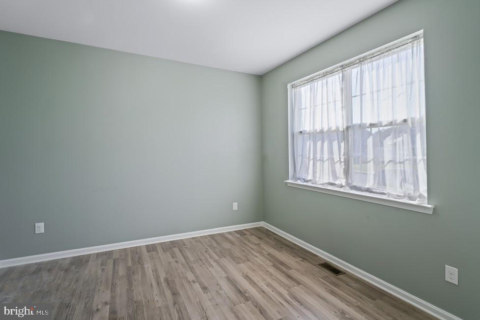 705 Beechwood Drive Deptford, NJ 08096 - Photo 6 of 39 an empty room with wooden floor and windows