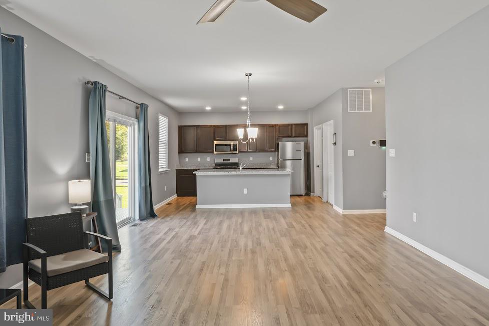 705 Beechwood Drive Deptford, NJ 08096 - Photo 9 of 39 a view of a kitchen with furniture and wooden floor