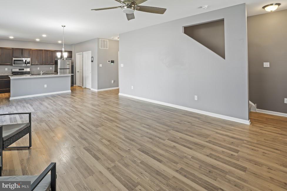 705 Beechwood Drive Deptford, NJ 08096 - Photo 10 of 39 wooden floor in an empty room with a kitchen