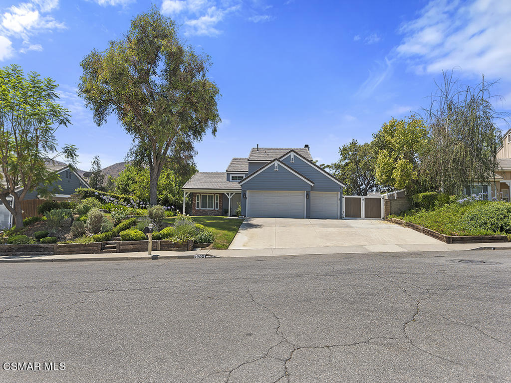 1902 Rambling Road Simi Valley, CA 93065 - Photo 19 of 67 a front view of a house with a yard and garage