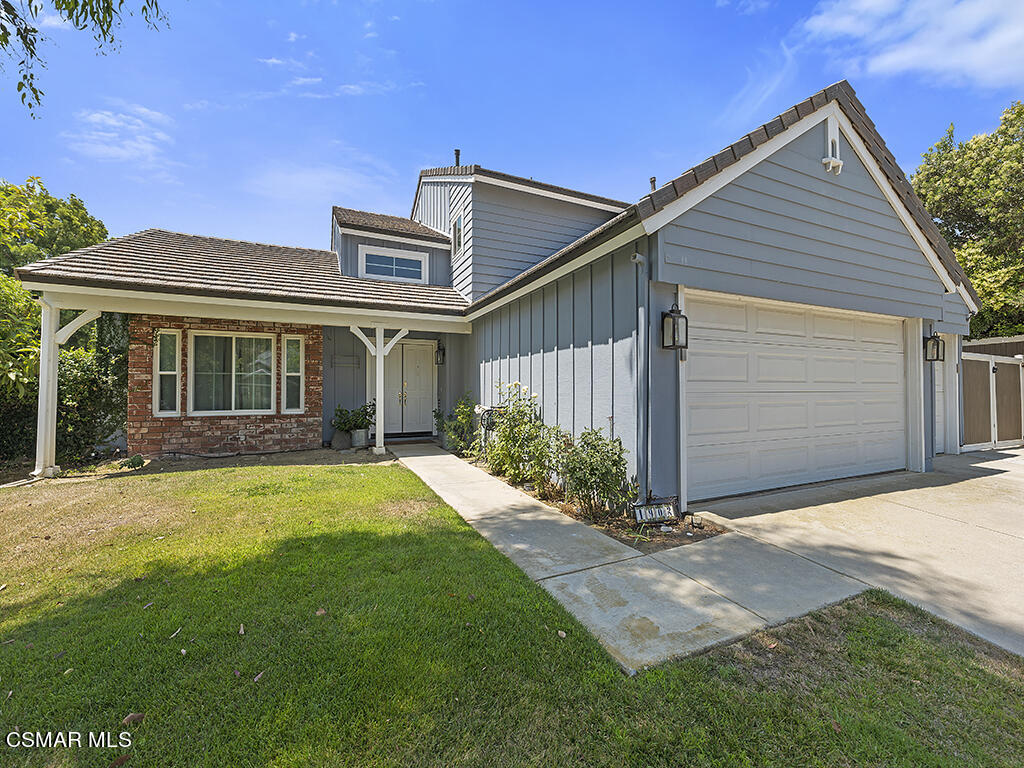 1902 Rambling Road Simi Valley, CA 93065 - Photo 22 of 67 a front view of a house with a yard and garage