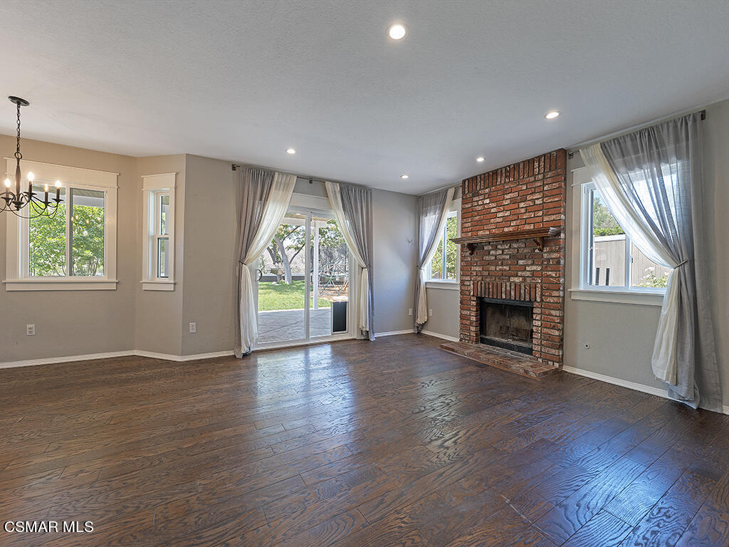 1902 Rambling Road Simi Valley, CA 93065 - Photo 27 of 67 an empty room with wooden floor fireplace and windows