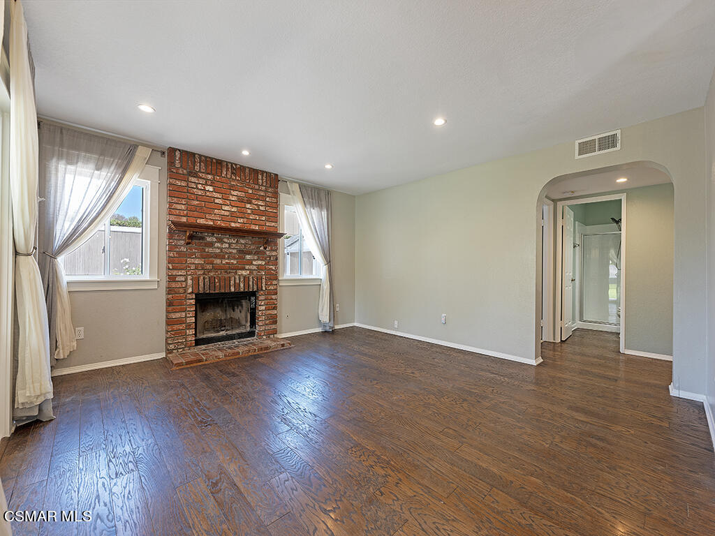 1902 Rambling Road Simi Valley, CA 93065 - Photo 28 of 67 an empty room with wooden floor a fireplace and windows