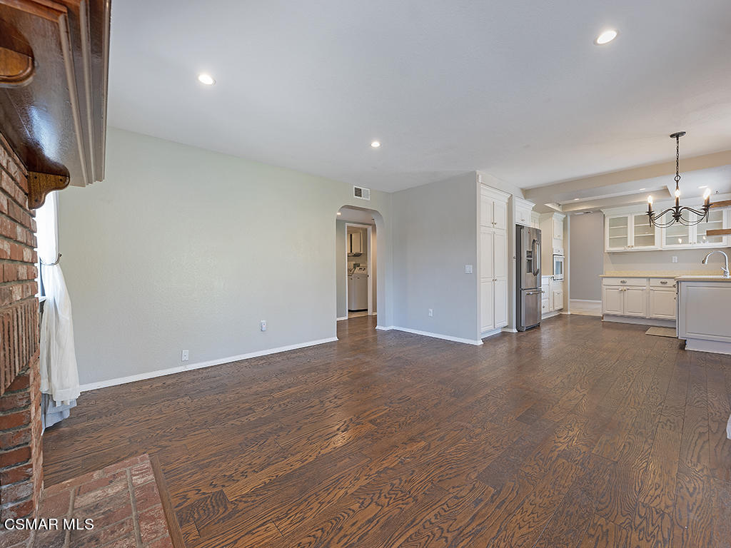1902 Rambling Road Simi Valley, CA 93065 - Photo 30 of 67 an empty room with a fireplace and wooden floor
