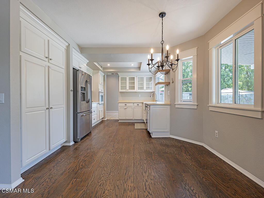 1902 Rambling Road Simi Valley, CA 93065 - Photo 31 of 67 a view of a kitchen with refrigerator and wooden floor