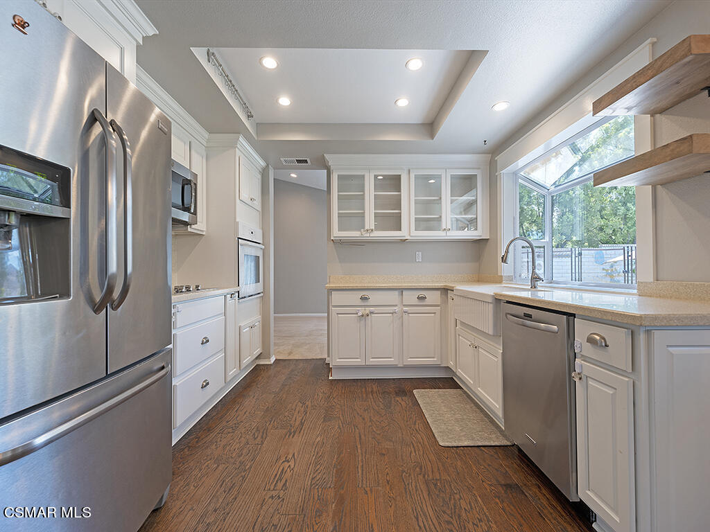 1902 Rambling Road Simi Valley, CA 93065 - Photo 32 of 67 a kitchen with stainless steel appliances a refrigerator sink and cabinets