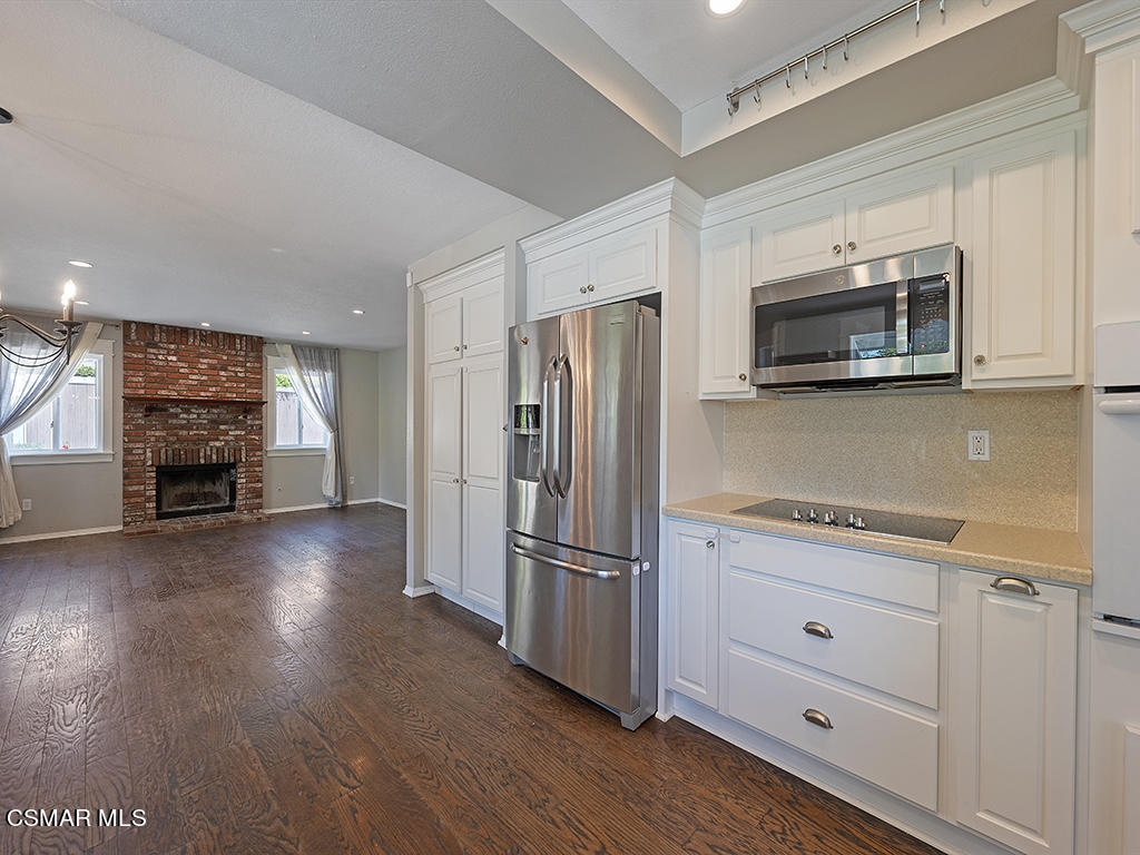 1902 Rambling Road Simi Valley, CA 93065 - Photo 34 of 67 a kitchen with granite countertop a refrigerator microwave and stove top oven