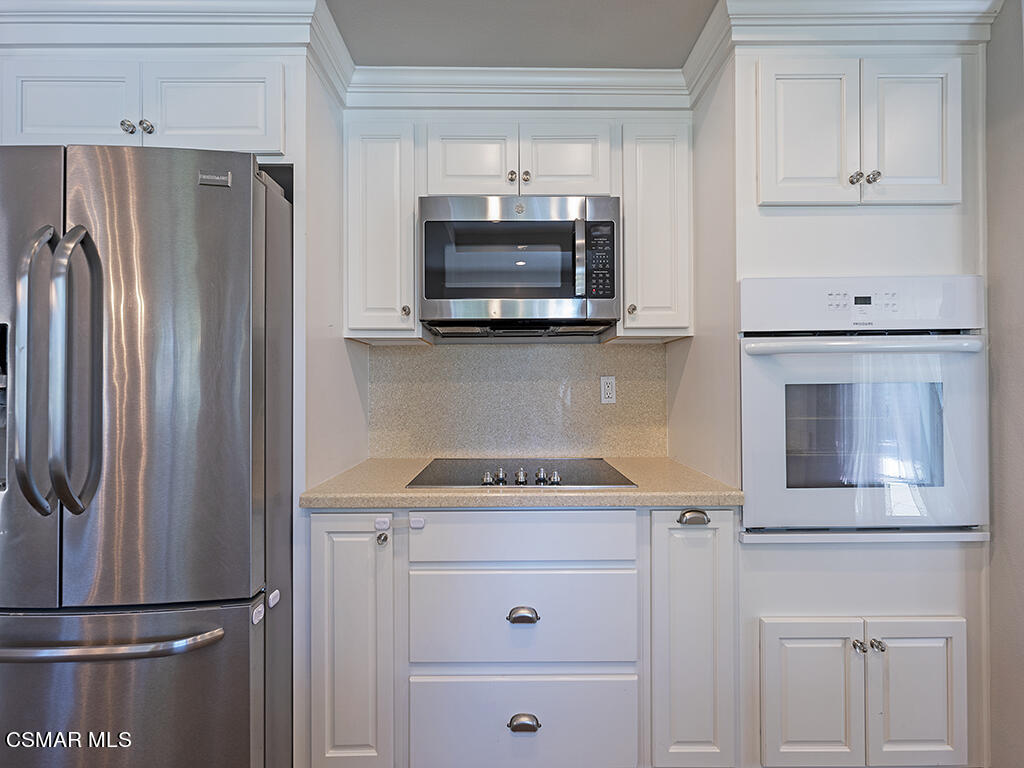 1902 Rambling Road Simi Valley, CA 93065 - Photo 35 of 67 a kitchen with white cabinets and stainless steel appliances